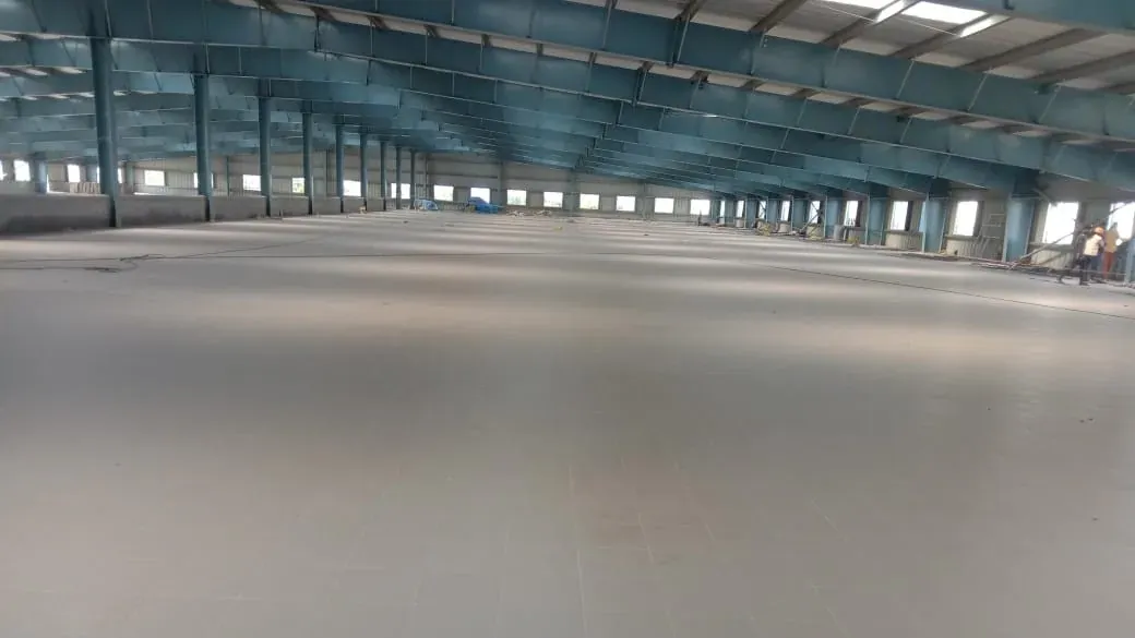 Heavy-duty industrial flooring across a warehouse bay